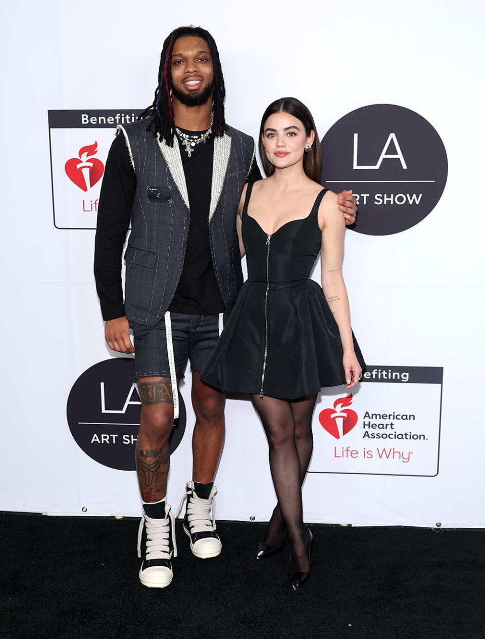 (L-R) Damar Hamlin and Lucy Hale attend the 2024 LA Art Show Opening Night Party at Los Angeles Convention Center on February 14, 2024 in Los Angeles, California.