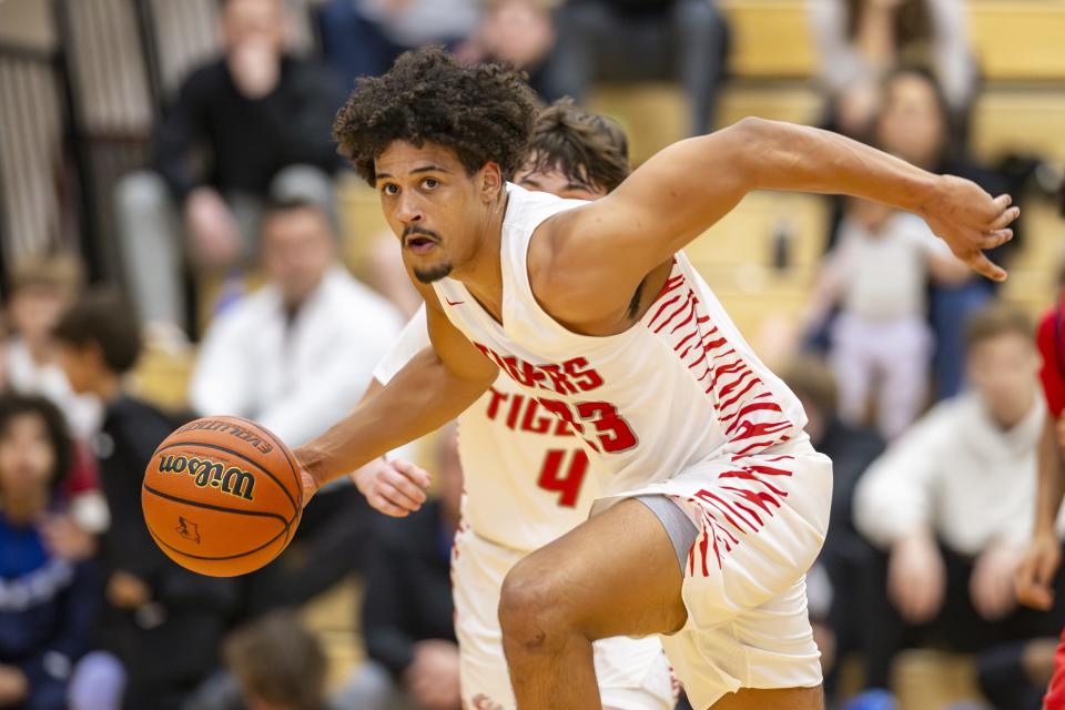 Fishers High School senior Keenan Garner (23) runs up court with the ball during the first half of a game in the Forum Tipoff Classic against Kokomo High School, Saturday, Dec. 9, 2023, at Southport High School.