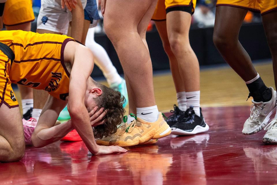 Windsor's Madden Smiley stays down on the court after getting shaken up during a class 5A Final 4 game against Vista PEAK Prep at the Denver Coliseum in Denver, Colo., on Thursday, March 7, 2024