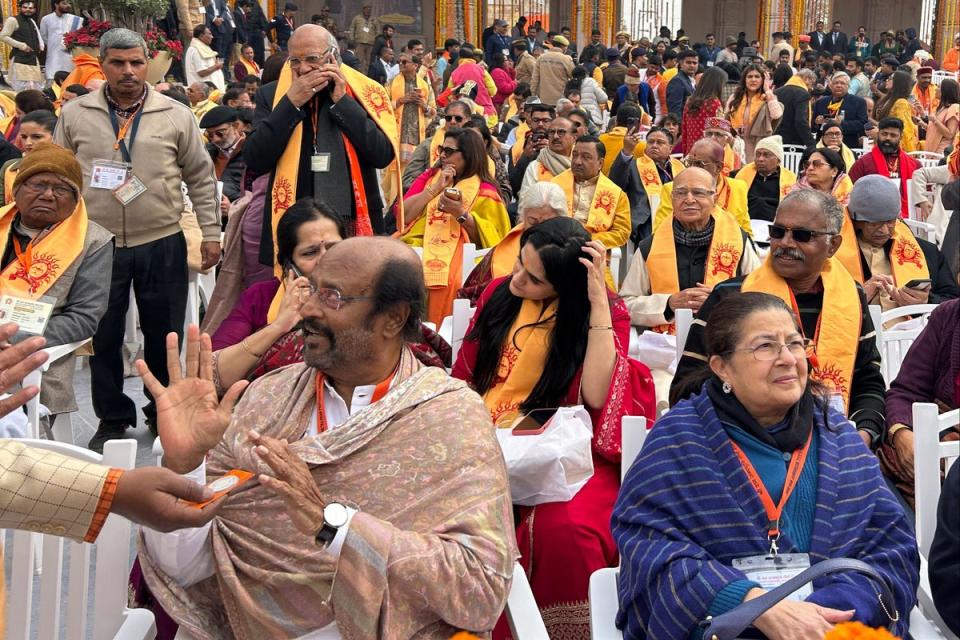 Indian actor Rajinikanth, left, along with other chief guests sit ahead of the opening of the temple (AP)