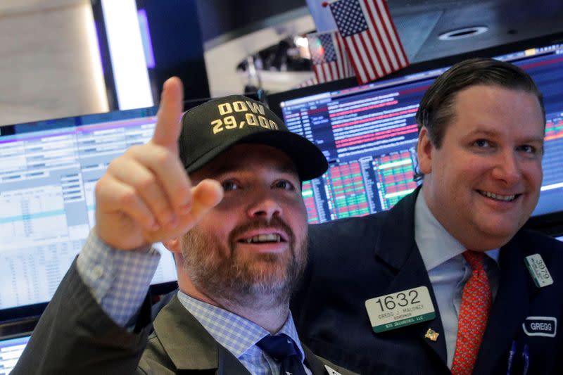 Traders work on the floor at the NYSE in New York