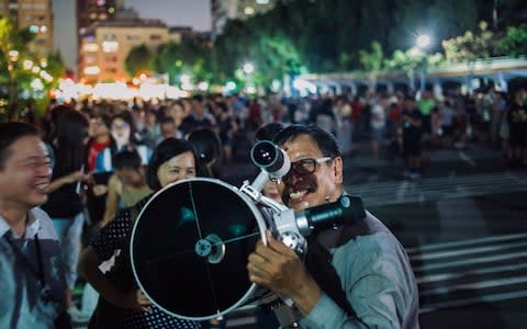 People set up telescopes to witness a rare lunar eclipse near National Dr. Sun Yat-sen Memorial Hall in Taiwan  - Credit: Billy H.C. Kwok/Getty