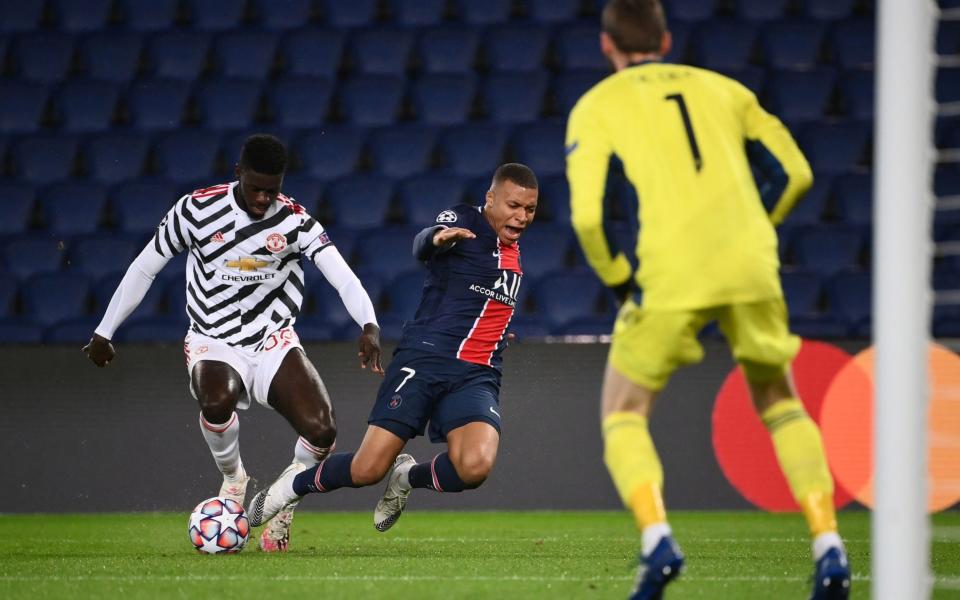 Axel Tuanzebe takes the ball off Kylian Mbappe - AFP