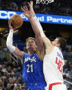 Los Angeles Clippers center Ivica Zubac (40) blocks a shot attempt by Orlando Magic center Moritz Wagner (21) during the first half of an NBA basketball game, Friday, March 29, 2024, in Orlando, Fla. (AP Photo/John Raoux)