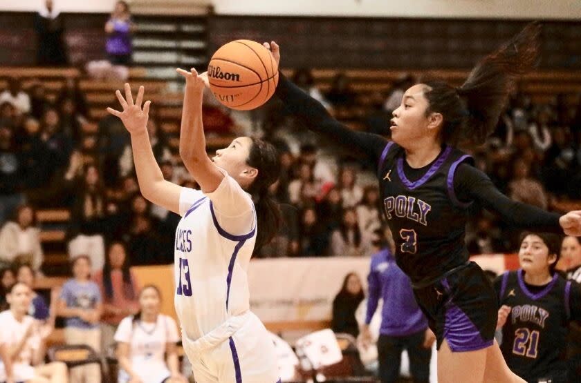 Poly guard Hannah Listing blocks a shot by LACES guard Maya Sano in the City Section Division I girls' basketball final.