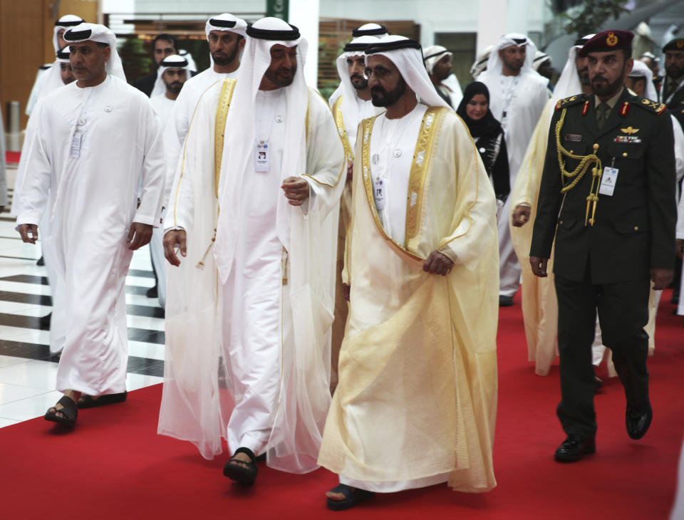 Abu Dhabi's crown prince, Sheikh Mohammed bin Zayed Al Nahyan, left, speaks to Dubai's ruler, Sheikh Mohammed bin Rashid Al Maktoum, right, at the International Defense Exhibition and Conference in Abu Dhabi, United Arab Emirates, Sunday, Feb. 17, 2019. The biennial arms show in Abu Dhabi comes as the United Arab Emirates faces increasing criticism for its role in the yearlong war in Yemen. (AP Photo/Jon Gambrell)