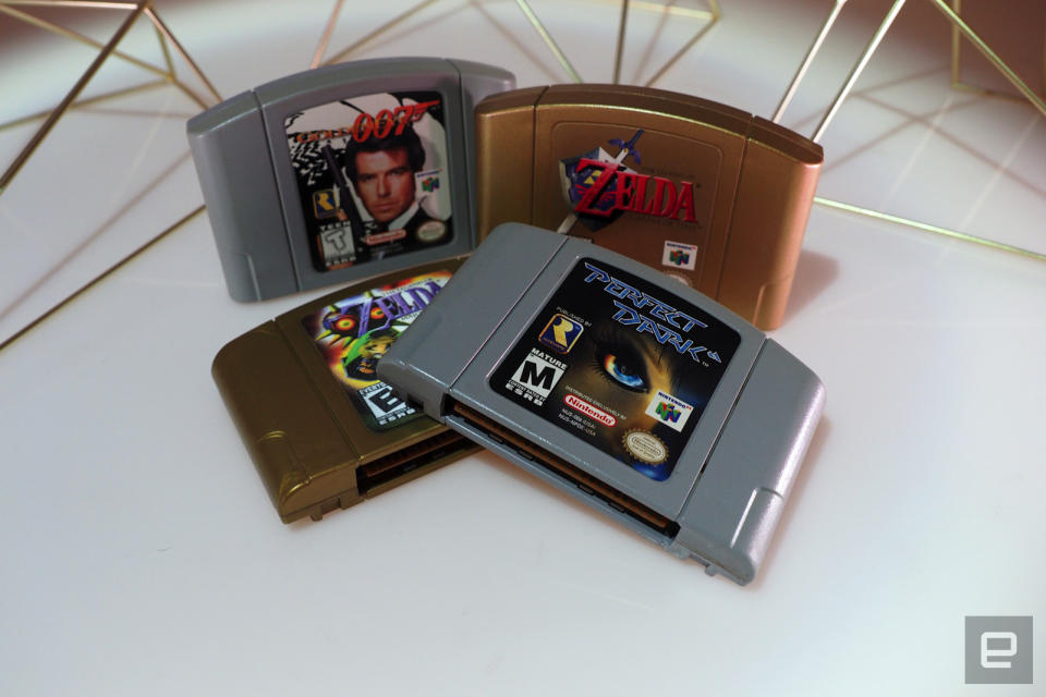 <p>Nintendo 64 on a white table with games</p>
