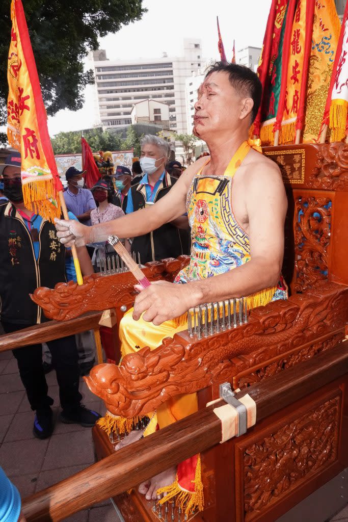 六十歲乩童林冬生需坐滿三年釘轎才能為主子建凌霄寶殿。（記者陳俊文攝）