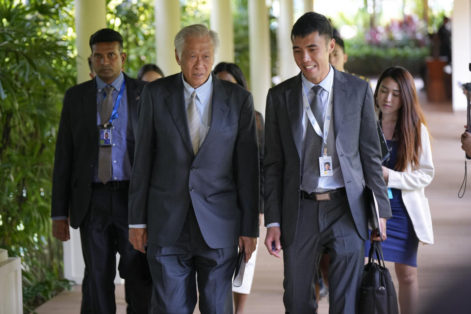 Singapore's Defense Minister Ng Eng Hen, center left, talks with his staff member as he arrives for U.S.-South East Asia (SEA) Defense Ministers' Informal Meeting on the sidelines of the 20th International Institute for Strategic Studies (IISS) Shangri-La Dialogue, Asia's annual defense and security forum, in Singapore, Friday, June 2, 2023. (AP Photo/Vincent Thian)