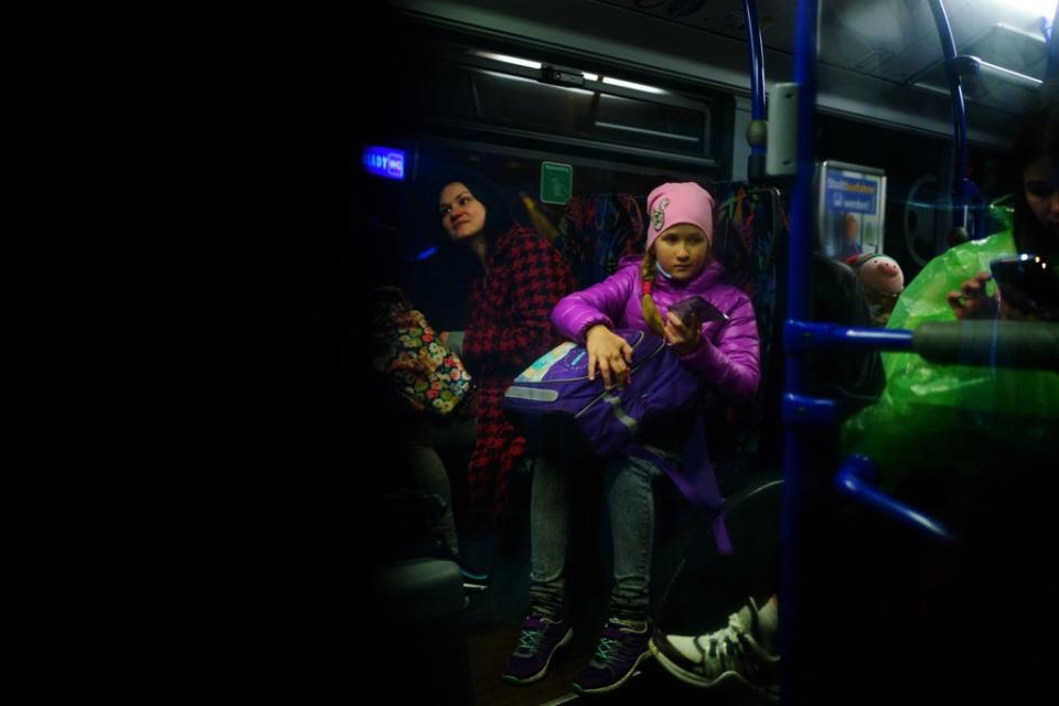 A young Ukrainian refugee sits on a bus bound for Przemysl after crossing the border point from Ukraine into Medyka, Poland (Victoria Jones/PA) (PA Wire)