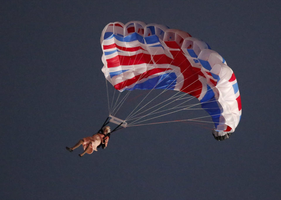 A performer playing the role of Britain's Queen Elizabeth parachutes from a helicopter during the opening ceremony of the London 2012 Olympic Games at the Olympic Stadium July 27, 2012. REUTERS/Fabrizio Bensch (BRITAIN - Tags: OLYMPICS SPORT) 