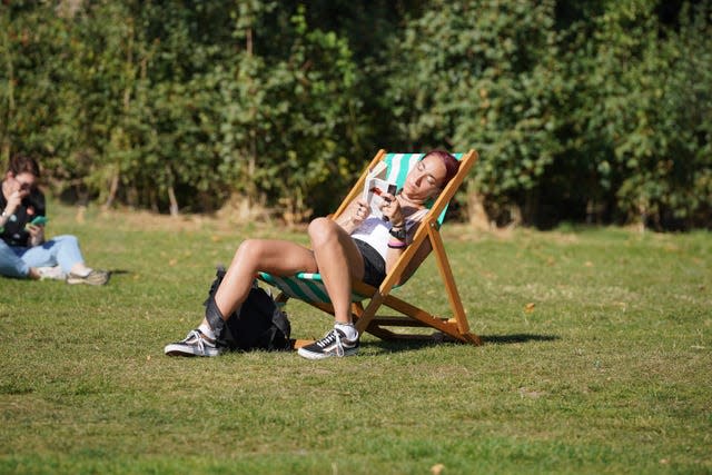 People enjoying the hot weather in Green Park, central London. 