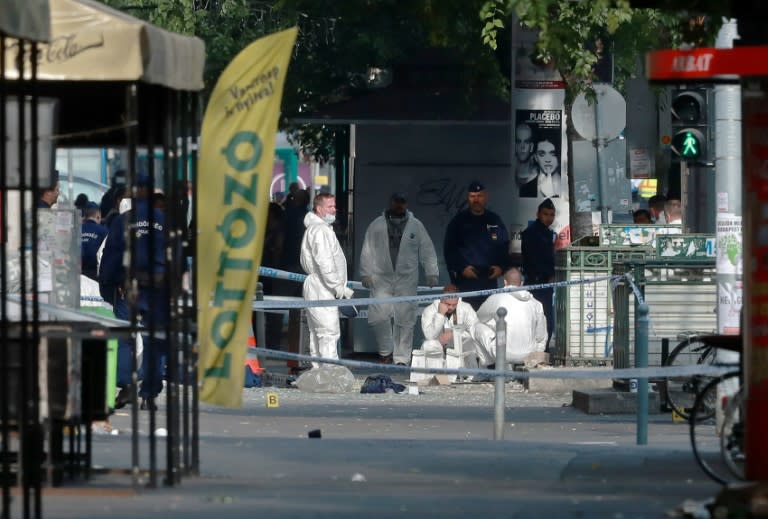 Hungarian police officials investigate after an explosion which was heard across central Budapest, blew out the ground floor shopfront and damaged nearby buildings and cars