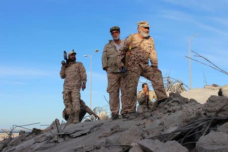 Fighters of Libyan forces allied with the U.N.-backed government stand atop the ruins of a house as they are close to securing last Islamic State holdouts in Sirte, Libya December 5, 2016. REUTERS/Ayman Sahely