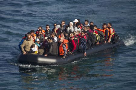 Refugees and migrants arrive on a overcrowded dinghy on the Greek island of Lesbos, after crossing a part of the Aegean Sea from the Turkish coast, October 5, 2015. REUTERS/Dimitris Michalakis