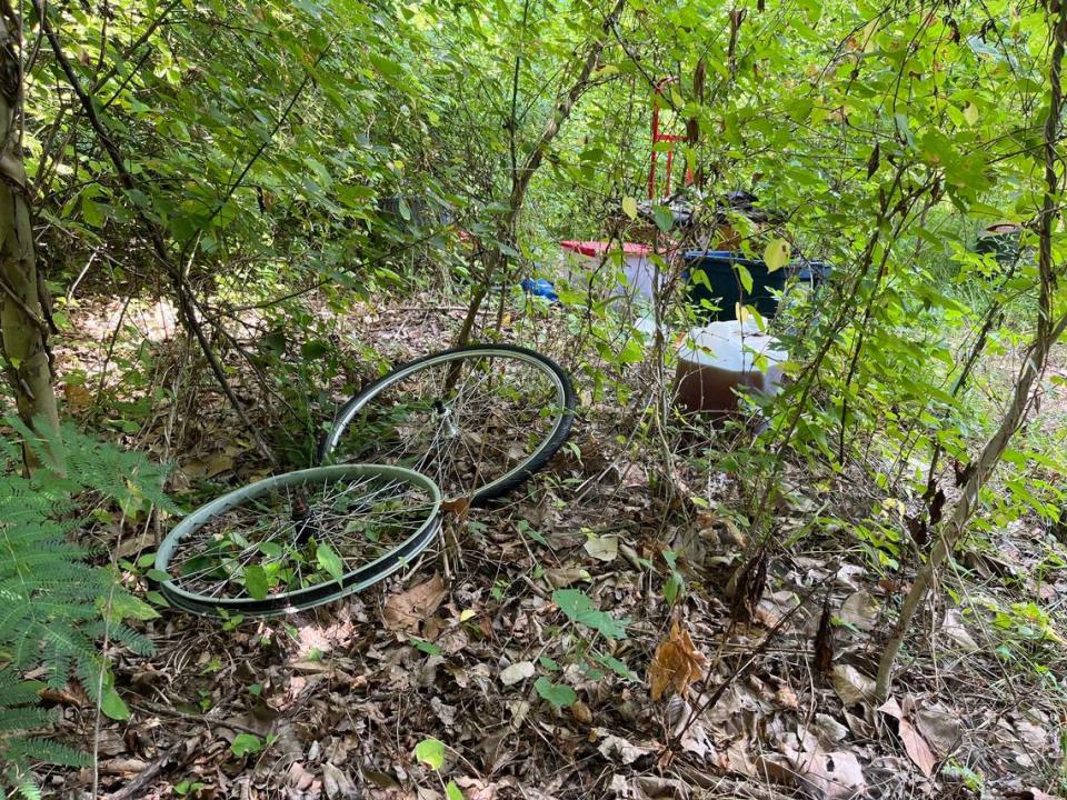 A squatters camp along the MetroBikeLink Trail in Swansea includes bicycle wheels and tubs of clothing. Many people living in such camps use bikes for transportation because they don’t own cars. Teri Maddox/tmaddox@bnd.com