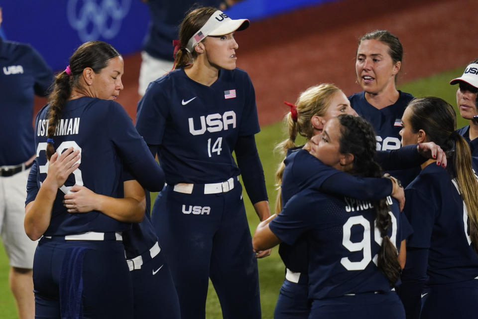 Members of team United States react after a softball game against Japan at the 2020 Summer Olympics, Tuesday, July 27, 2021, in Yokohama, Japan. Japan won 2-0. (AP Photo/Matt Slocum)