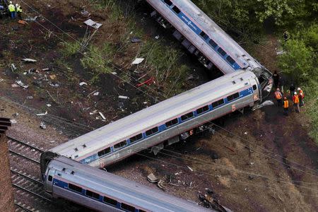 Emergency workers and Amtrak personnel inspect a derailed Amtrak train in Philadelphia, Pennsylvania in this May 13, 2015 file photo. REUTERS/Lucas Jackson/Files