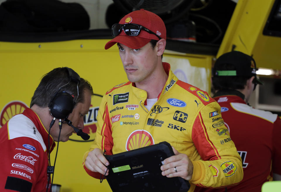 Joey Logano stands in the garage during practice for the NASCAR Cup auto race at the Homestead-Miami Speedway, Friday, Nov. 16, 2018, in Homestead, Fla. (AP Photo/Terry Renna)