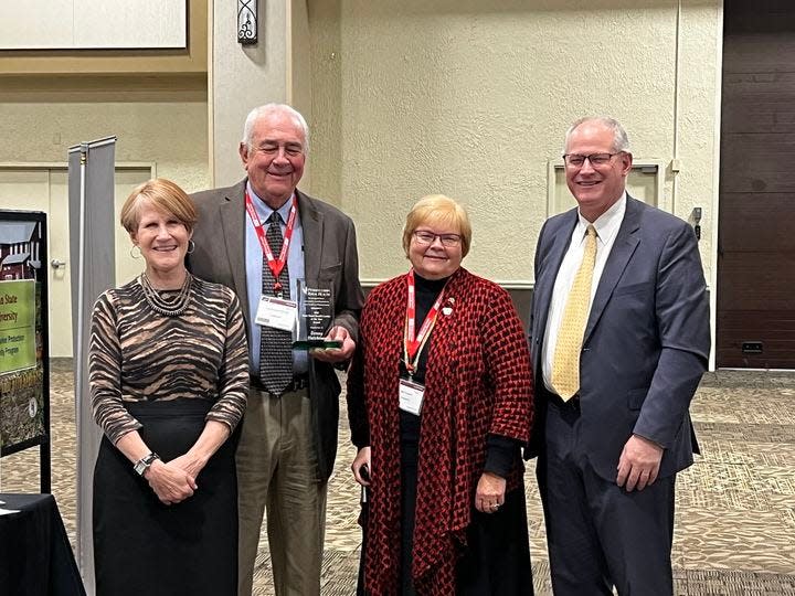 Somerset County farmer Denny Hutchison was named Rural Health Leader of the Year by the Pennsylvania Office of Rural Health. In November he received an award. Pictured are, from left, Lisa Davis, director of PORH; Hutchison; the Rev. Nila Cogan, of St. Thomas Lutheran Church, Hooversville; and Mark Critz, state Rural Development Council executive director.