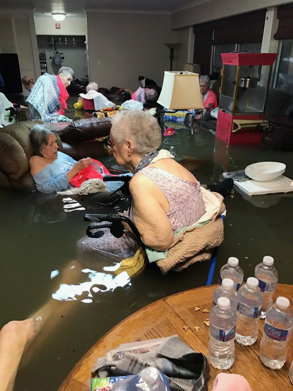 <p>In this Sunday, Aug. 27, 2017, photo provided by Trudy Lampson, residents of the La Vita Bella nursing home in Dickinson, Texas, sit in waist-deep flood waters caused by Hurricane Harvey. Authorities said all the residents were safely evacuated from the facility. (Photo: Trudy Lampson via AP) </p>