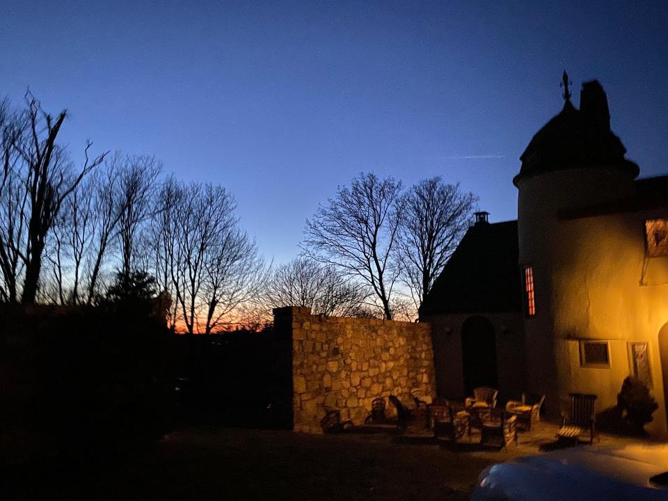 The sunset casts beautiful light to the west of the former Pope estate carriage house in Cohasset.