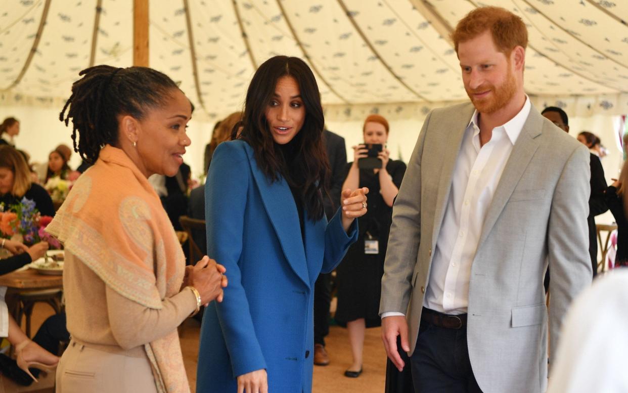 The Duke and Duchess of Sussex with her mother Doria at the launch of the Together cookbook - AFP