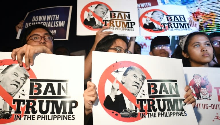 Student activists hold anti-Donald Trump banners at a rally ahead of the 31st ASEAN Summit in the Philippine capital Manila