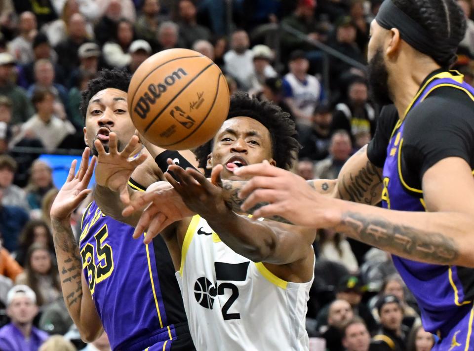 Utah Jazz guard Collin Sexton (2) his hit by Los Angeles Lakers forward <a class="link " href="https://sports.yahoo.com/nba/players/5583" data-i13n="sec:content-canvas;subsec:anchor_text;elm:context_link" data-ylk="slk:Christian Wood;sec:content-canvas;subsec:anchor_text;elm:context_link;itc:0">Christian Wood</a> (35) and Los Angeles Lakers forward Anthony Davis (3) as he drives toward the hoop as Utah and Los Angeles play at the Delta Center in Salt Lake City on Saturday, Jan. 13, 2024. | Scott G Winterton, Deseret News