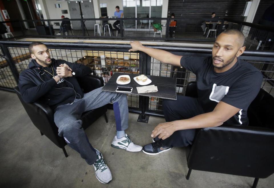 In this Jan. 12, 2017, photo, Utah Jazz's Boris Diaw, right, and Rudy Gobert speak during an interview, in Salt Lake City. Diaw and Gobert have known each other for years and were members of the French national team in the Rio Olympics. Their comfort level is a significant reason the Jazz are in the thick of the playoff race heading down the stretch after the All-Star break. (AP Photo/Rick Bowmer)