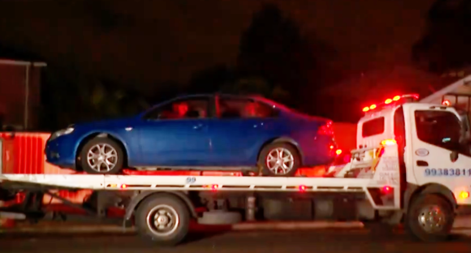 A blue Ford Falcon sedan on the back of a tow truck, after a crash in Bexley in Sydney's southwest overnight. 