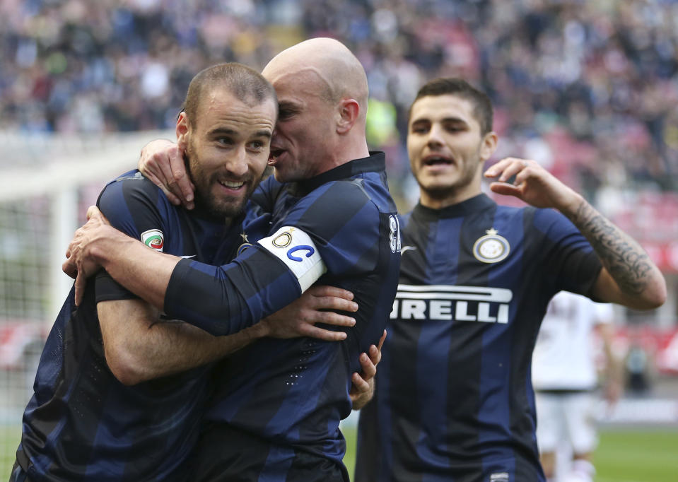 Inter Milan forward Rodrigo Palacio, left, of Argentina, celebrates with his teammates Esteban Cambiasso, center, and Mauro Icardi, of Argentina, after scoring during the Serie A soccer match between Inter Milan and Torino at the San Siro stadium in Milan, Italy, Sunday, March 9, 2014. (AP Photo/Antonio Calanni)