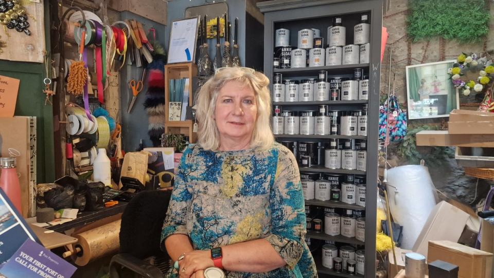 Sally Dart, who runs Topsom 50 near Brixham Harbour, a shop that sells artwork, furniture, and flowers. (Piers Mucklejohn/PA Wire)