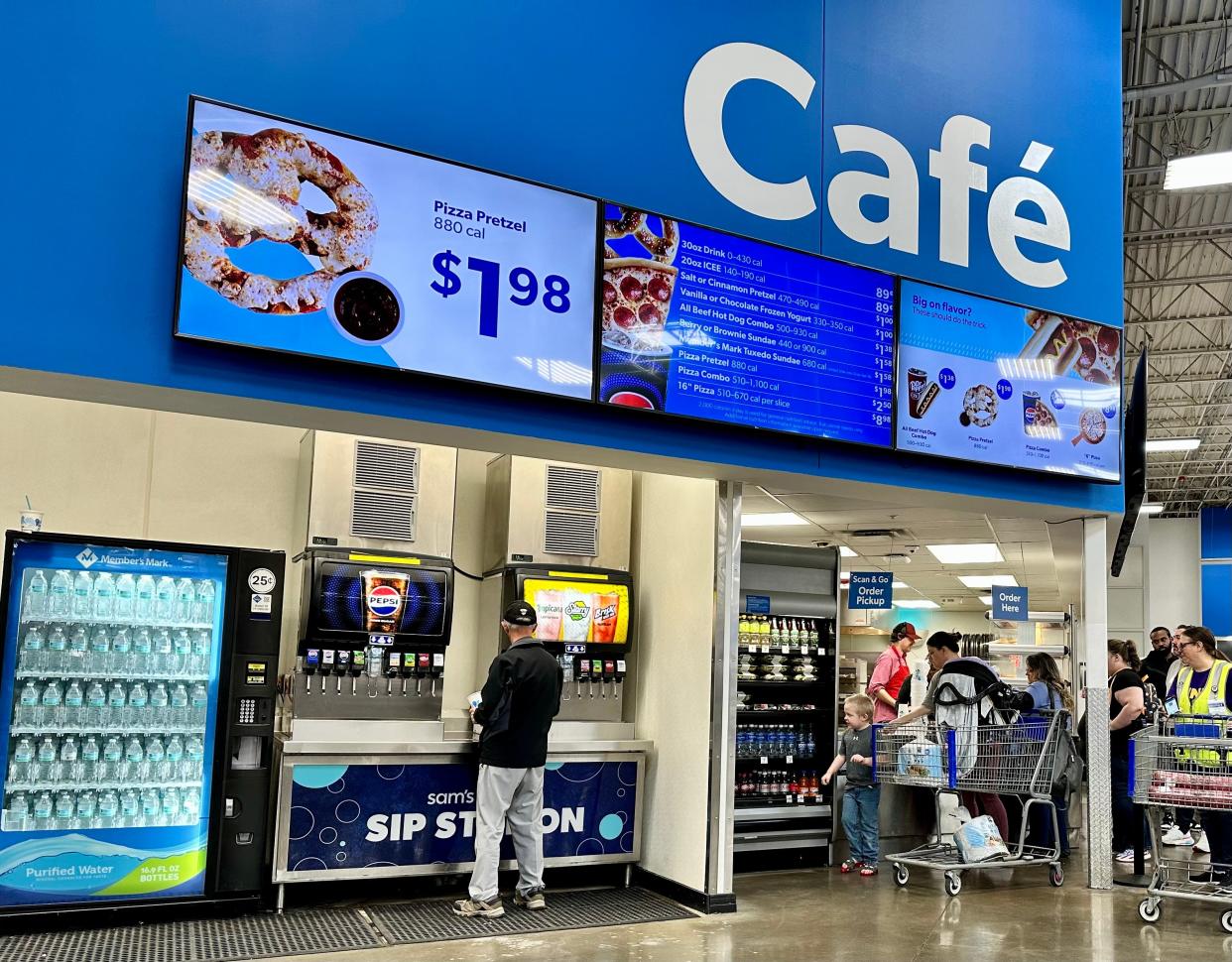 A long line of customers awaits their food at Sam's Club's food court. The staff is friendly and efficient, so the line moves quickly.