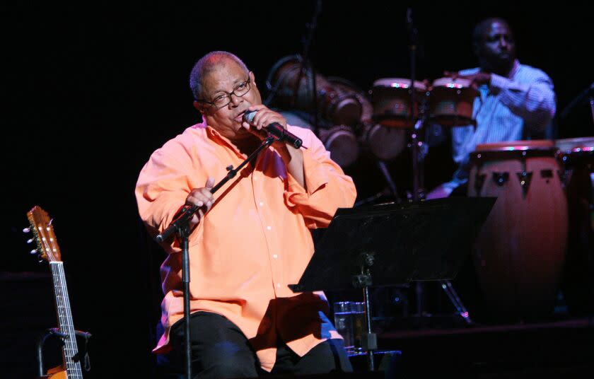 FILE- In this May 27, 2006, file photo, Cuban singer and composer Pablo Milanes performs during a concert at the National Theater in Santo Domingo. Documents obtained by The Associated Press show a U.S. agency decided to infiltrate an arts and music festival put on by Milanes' family, part of a plan to recruit unwitting rappers to spark a youth movement against the government. (AP Photo/Ramon Espinosa, File)