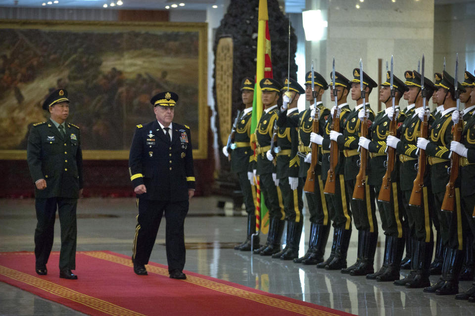 FILE - China's People's Liberation Army (PLA) Gen. Li Zuocheng, left, and U.S. Army Chief of Staff Gen. Mark Milley, center, review an honor guard during a welcome ceremony at the Bayi Building in Beijing, Tuesday, Aug. 16, 2016. (AP Photo/Mark Schiefelbein, Pool, File)