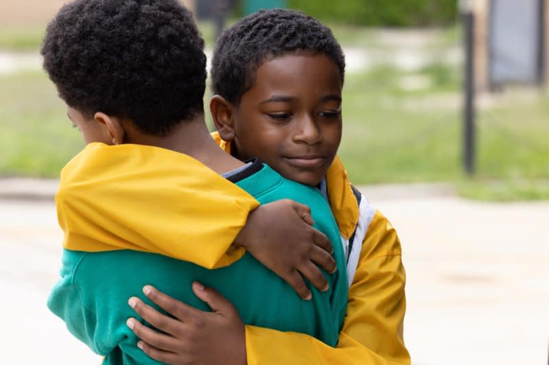 Eric (Gian Knight Ramirez, R) hugs Malik (Blake Cameron James). Photo courtesy of Sony Pictures Classics