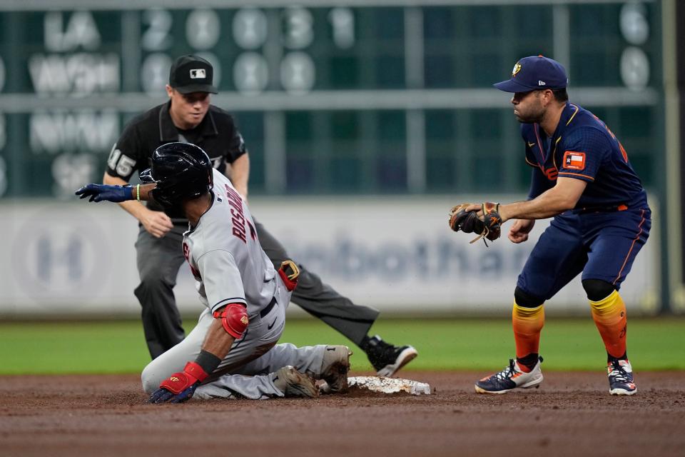 Cleveland Guardians' Amed Rosario (1) slides safely into second as Houston Astros second baseman Jose Altuve reaches for the ball during the third inning of a baseball game Monday, May 23, 2022, in Houston. Rosario advanced to second on a throwing error by Houston Astros starting pitcher Luis Garcia. (AP Photo/David J. Phillip)