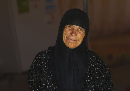 A Syrian refugee woman looks out from her tent at Suleymansah refugee camp in Akcakale in Sanliurfa province, Turkey, June 11, 2015. REUTERS/Osman Orsal