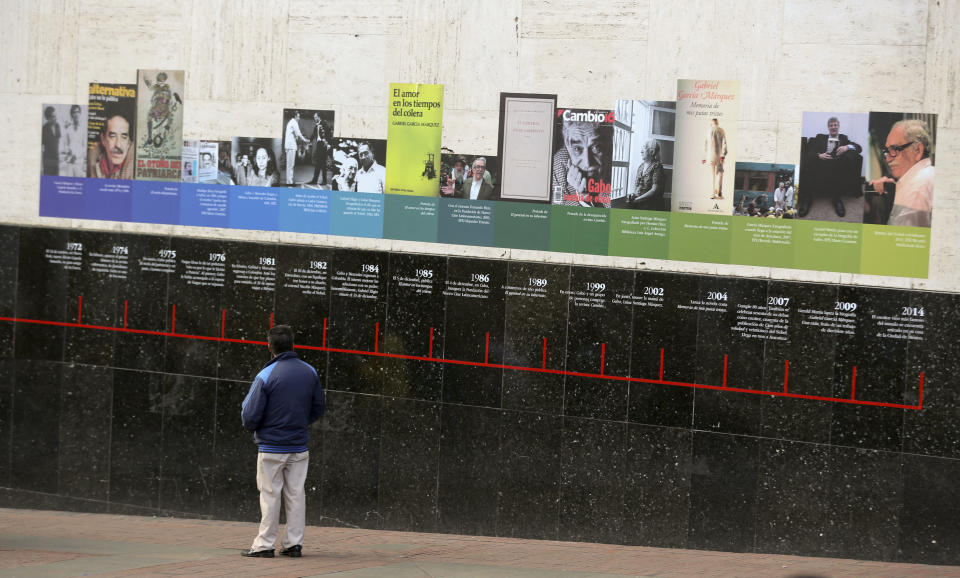 A man looks at a timeline of the life of the late Colombian author Gabriel Garcia Marquez on a wall at the Luis Angel Arango Library in downtown Bogota, Colombia, Thursday, April 17, 2014. The Nobel laureate died in Mexico City on Thursday. Garcia Marquez was among Latin America's most popular writers and widely considered the father of a literary style known as magic realism. (AP Photo/Ricardo Mazalan)