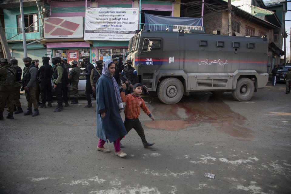 Kashmiris walk past the site of an attack on the outskirts of Srinagar, Indian controlled Kashmir, Thursday, Nov. 26, 2020. Anti-India rebels in Indian-controlled Kashmir Thursday killed two soldiers in an attack in the disputed region’s main city, the Indian army said.(AP Photo/Mukhtar Khan)