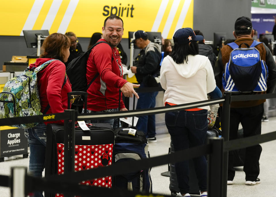 Travelers wait to check luggage into their Spirit Airlines at George Bush Intercontinental Airport, Tuesday, Nov. 21, 2023, in Houston. (Jason Fochtman/Houston Chronicle via AP)