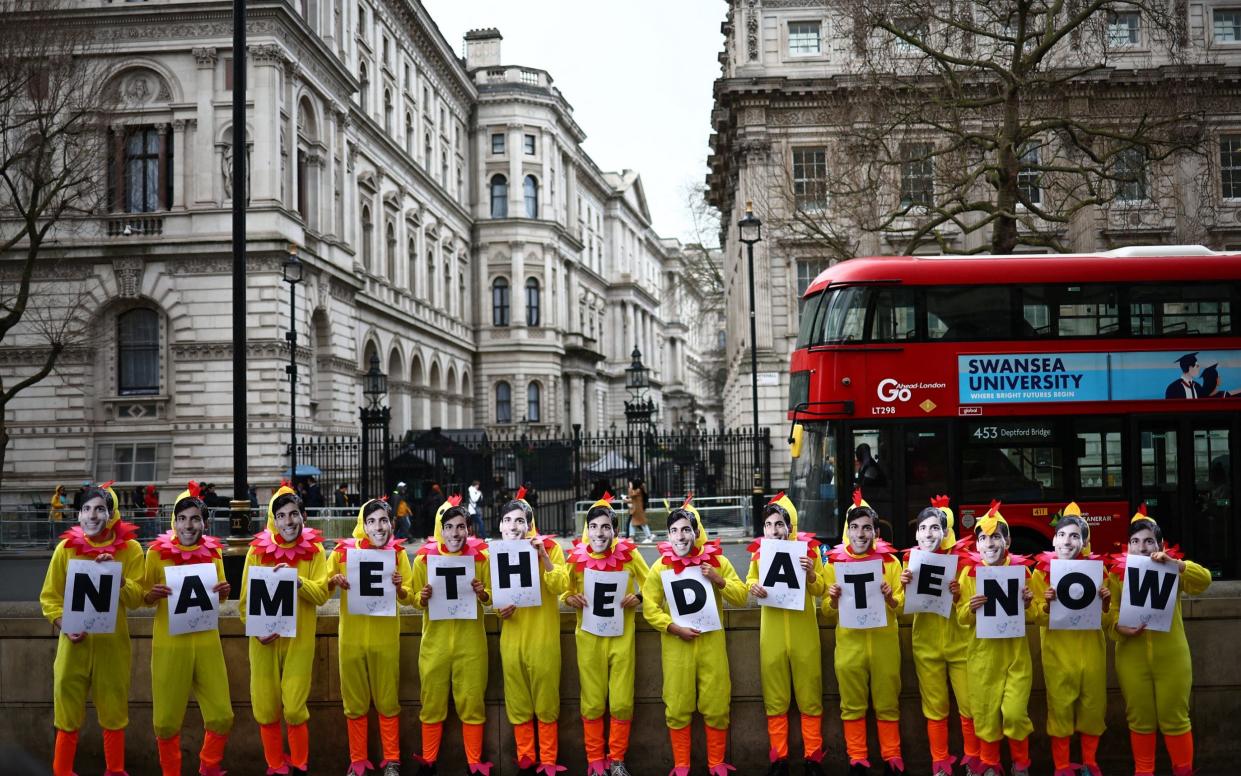 Labour activists dressed as chickens pose in front of Downing Street today