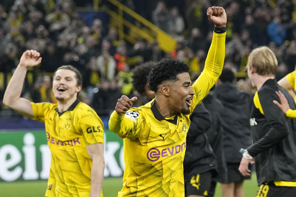 Dortmund's scorers Ian Maatsen, right, and Marcel Sabitzer, left, celebrate with the team after winning the Champions League quarterfinal second leg soccer match between Borussia Dortmund and Atletico Madrid at the Signal-Iduna Park in Dortmund, Germany, Tuesday, April 16, 2024. Dortmund won the match 4-2 and reached the semifinals against PSG. (AP Photo/Martin Meissner)