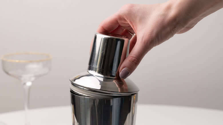 placing lid on cocktail shaker