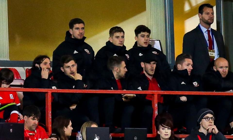 Gareth Bale sits in the stands with Joe Allen, Ben Davies, Aaron Ramsey, Wayne Hennessey and other members of the Wales squad.