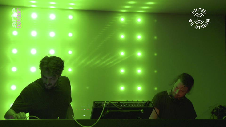 In this March 18, 2020, frame from video provided by Rundfunk Berlin-Brandenburg, DJ duo Gheist performs a set as part of the "United We Stream" event at the club Watergate in Berlin. The nightclubs in the German capital have decided to keep the beat going — at least online. Berlin's nightclubs were closed on March 13 in an attempt to slow the spread of the coronavirus. In response, some clubs formed a streaming platform to let DJs, musicians and artists continue to perform. (Rundfunk Berlin-Brandenburg via AP)