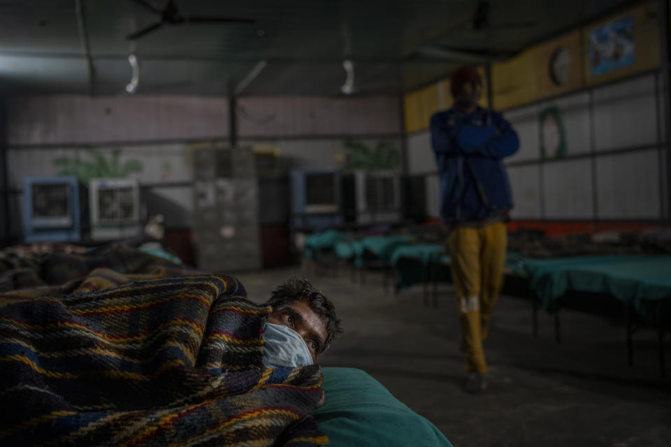 A homeless rests inside a night shelter in New Delhi, Wednesday, Dec. 28, 2022. Even though the city’s night shelters are a refuge to many who would otherwise find themselves sleeping near traffic-busy roundabouts and underpasses, most people there live in harsh conditions. Many night shelters are overcrowded, with unclean toilets. Rooms stench of rot. And sometimes there is no water. (AP Photo/Altaf Qadri)