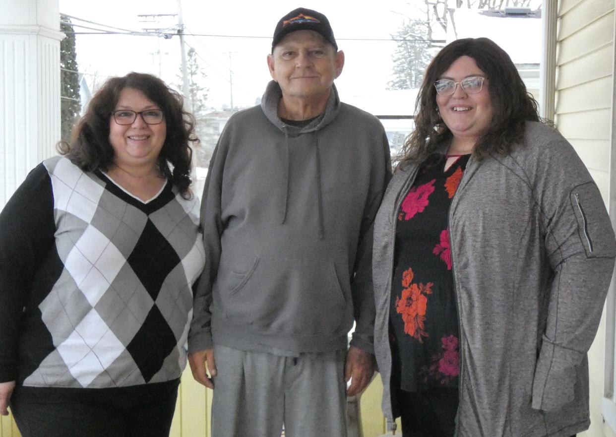 Lori and Jack Zornes stand on the front porch of their Woodlawn Avenue home with their oldest daughter, Kristena Cazzell, right, earlier this week.