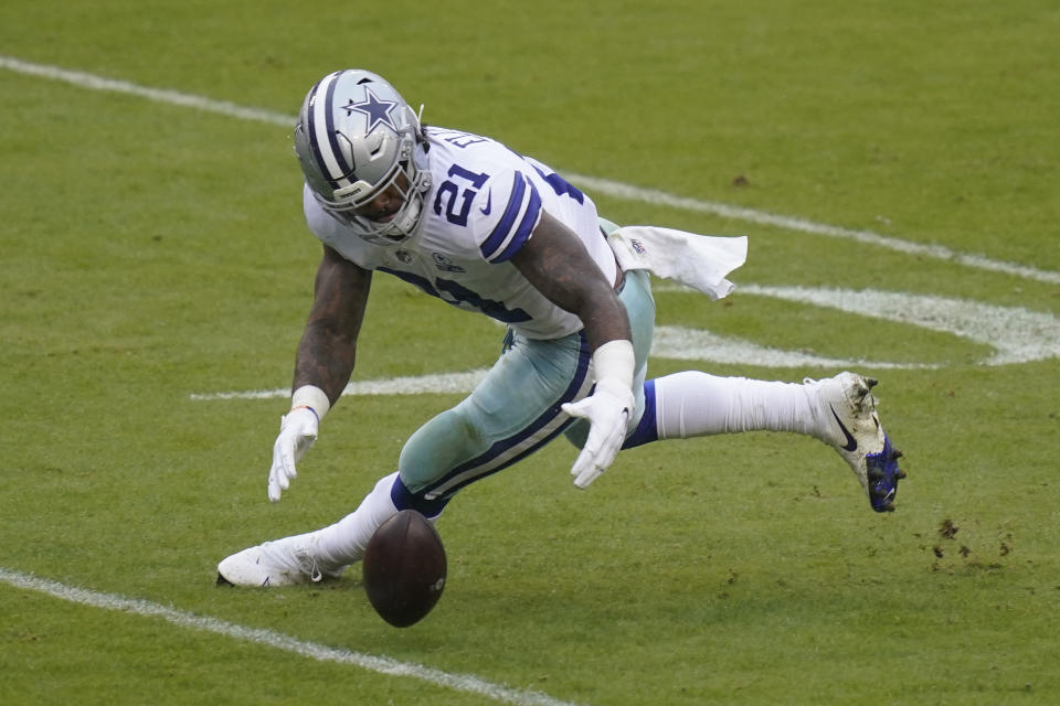 Dallas Cowboys running back Ezekiel Elliott (21) recovering a loose football during the second half of an NFL football game, Sunday, Oct. 25, 2020, in Landover, Md. (AP Photo/Patrick Semansky)